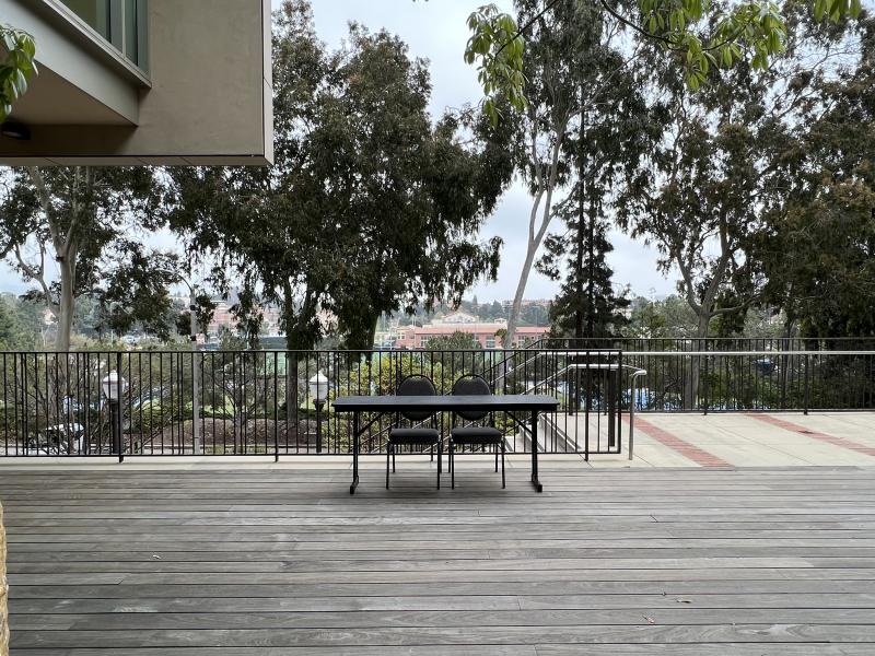 Table and two chairs set up on the patio in front of Bruin Plate.