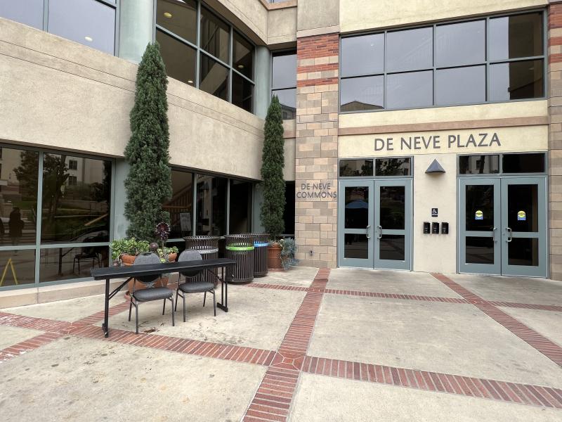 Table and two chairs set up next to the entrance of De Neve Dining.