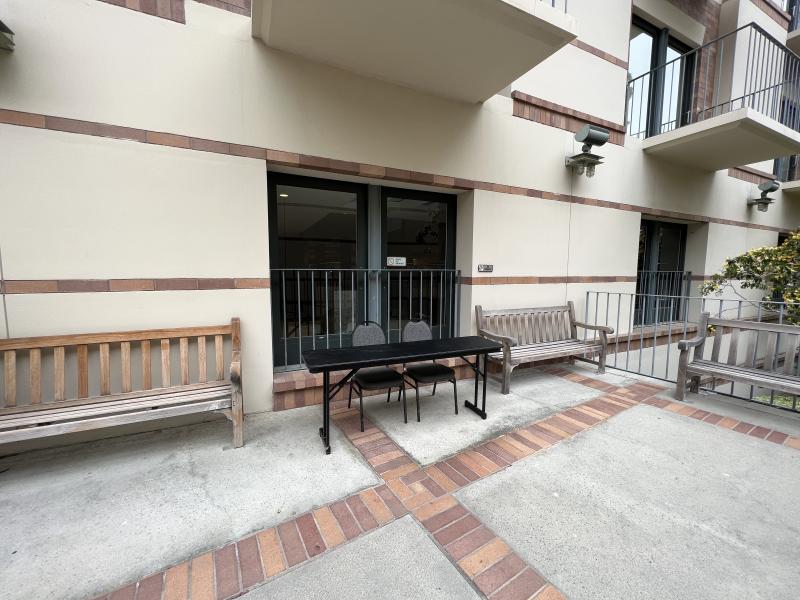 Table and two chairs set up next to the entrance of Epicuria at Covel.