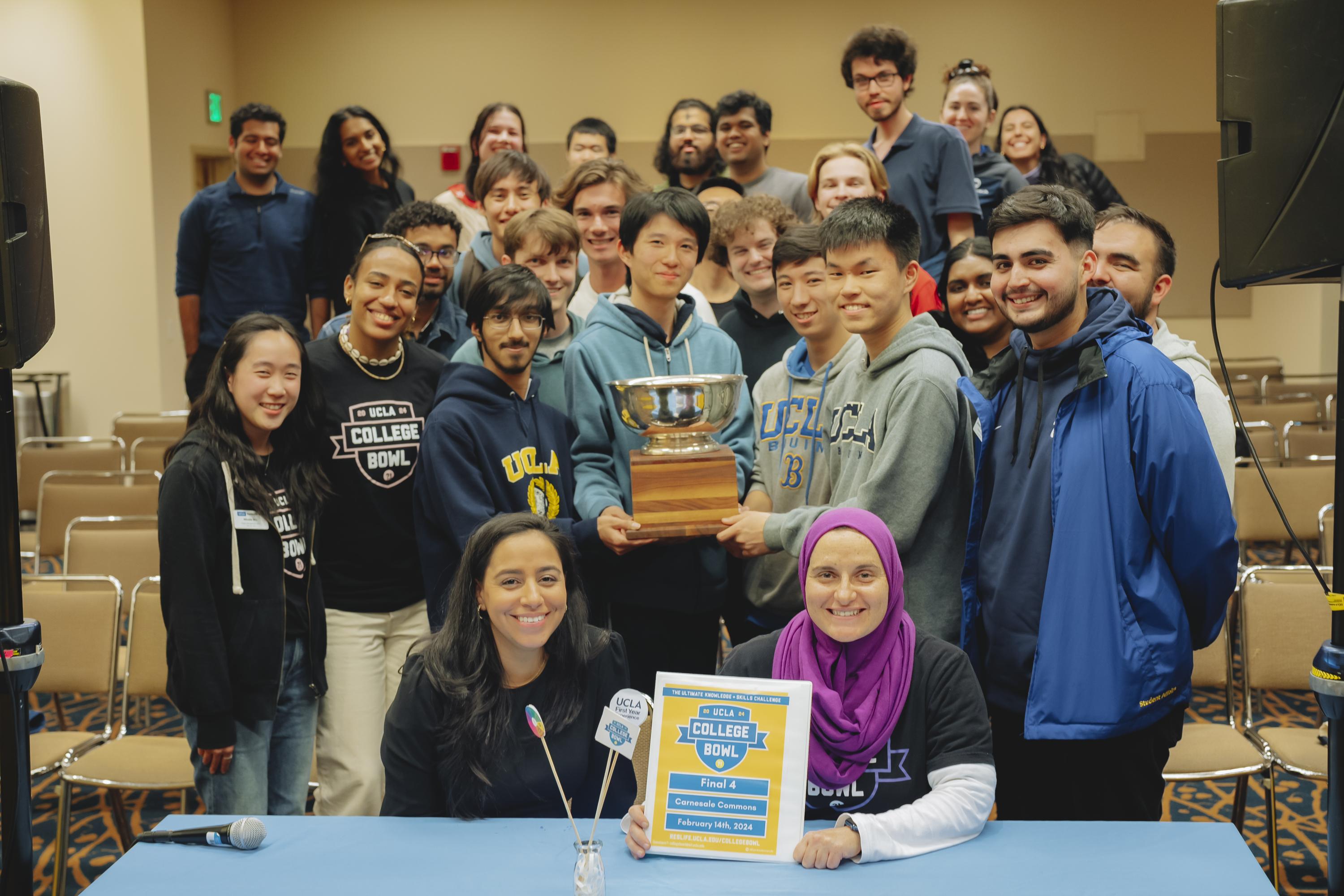 Image of winning team surrounded by judges and students.