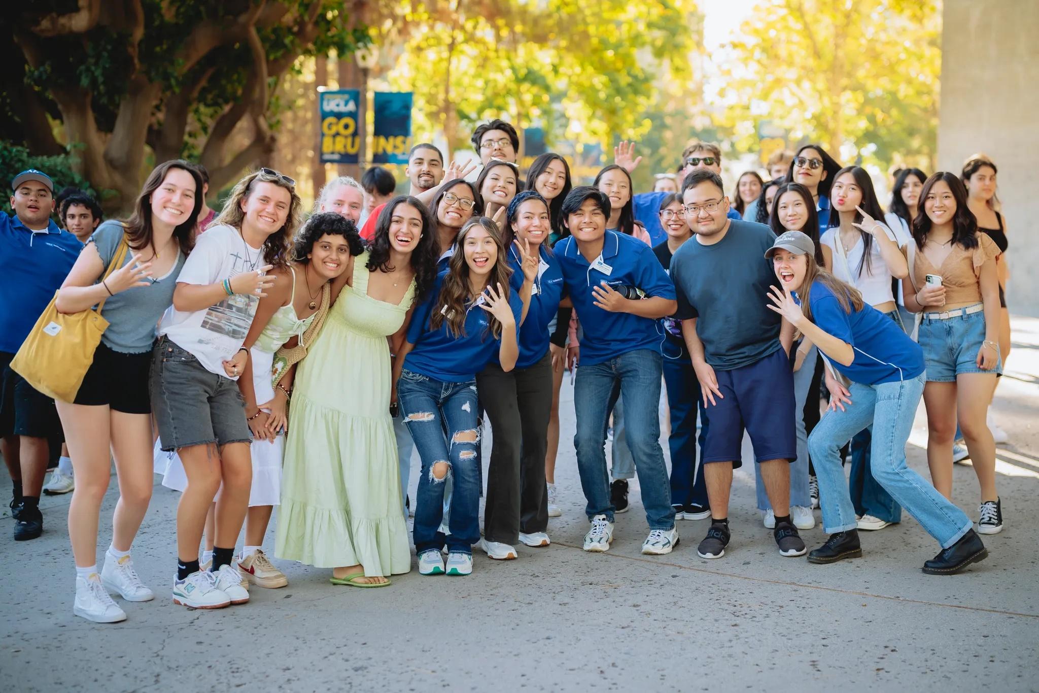 Group photo of Residential Life student staff and residents holding up "4s up" symbol.