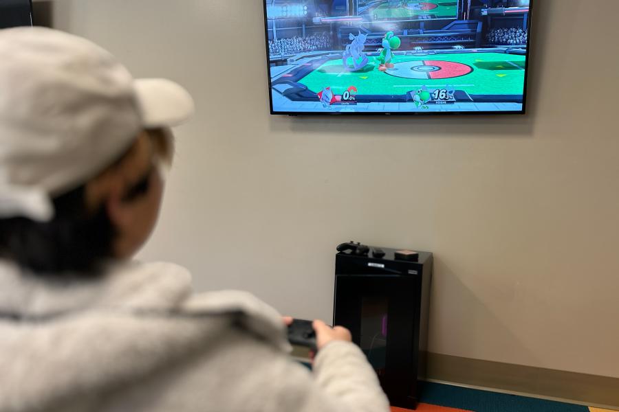 image shows a student playing smash bros on the nintendo switch