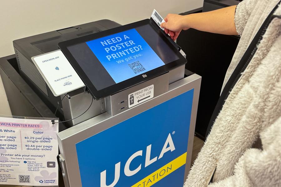 image displays a wepa printer as someone swipes their bruincard to operate it