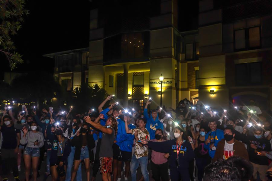 image shows a group of students with flashlights on 