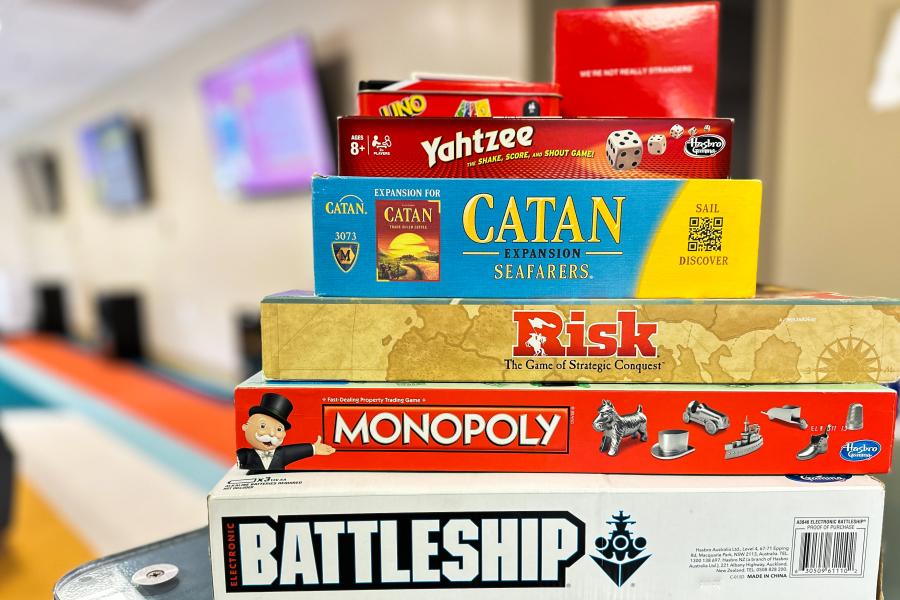 image shows multiple boards games stacked on top of each other