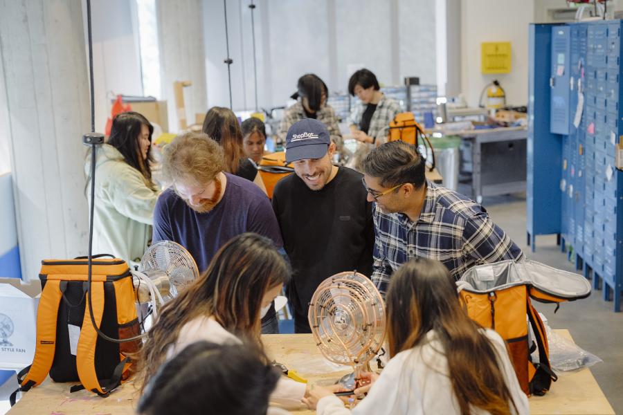 Faculty in Residence, Dr. Bharat in the UCLA Residential Life MakerSpace talking with two individuals.
